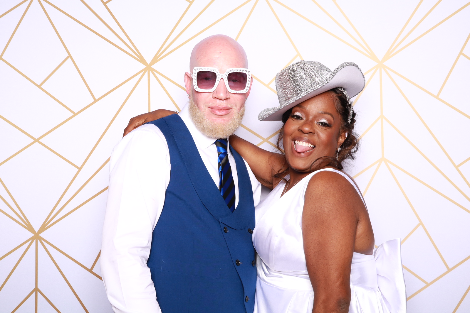 Wedding guests enjoying a bright custom photo booth backdrop